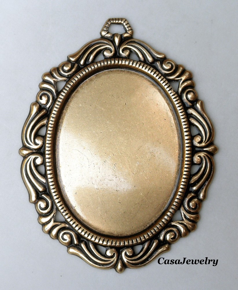 #1793 ANTIQUED GOLD 40×30 FILIGREE BORDERED BEZEL W/TOP HANG RING – 1 Pc