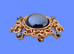 Vintage Filigree Brooch with a rich dark gray domed mirror-finished center stone