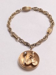 Vintage Mid-Century Gold Tone Lady on Bicycle Charm Bracelet