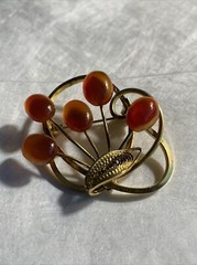 Vintage gold tone brooch with amber colored stones