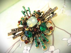large brooch gold tone with faux opal + red, green &clear zircons