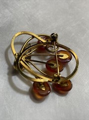 Vintage gold tone brooch with amber colored stones