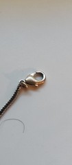 Bohemian design necklace with curved row of repeating leaf-or shield- shape pane