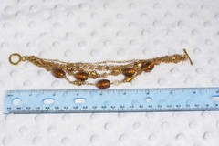 Vintage brass toned 7 strand toggle bracelet with Venetian foil type beading