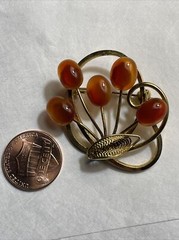 Vintage gold tone brooch with amber colored stones