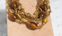 Vintage brass toned 7 strand toggle bracelet with Venetian foil type beading
