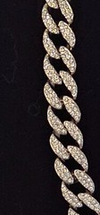 Cuban chain necklace silver tone one side many crystals other side plain.