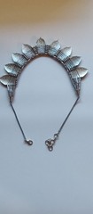 Bohemian design necklace with curved row of repeating leaf-or shield- shape pane
